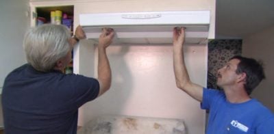 Danny and helper installing range hood.