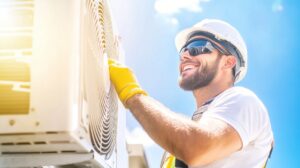 Happy technician in safety gear conducting HVAC maintenance.