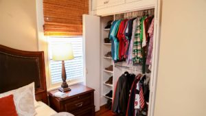 Bedroom closet with cubby holes for shoes and racks to hang shirts and jackets