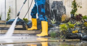 man pressure washing stairs