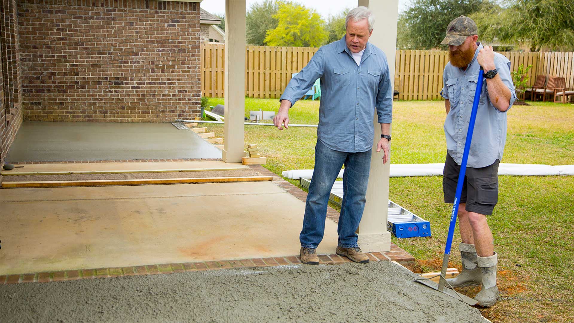 Danny Lipford looks at a wet concrete patio in production at the job site