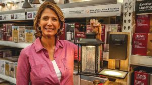 Jodi Marks, pictured with the Home Decorators Collection Portable Outdoor LED Wall Lantern Sconce