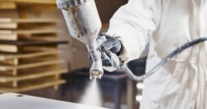 man using spray painter