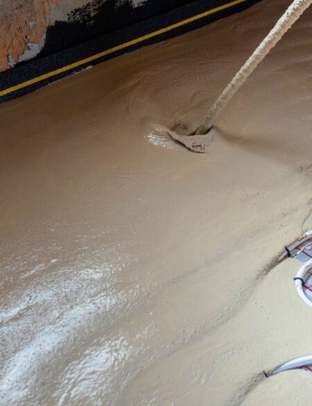 man installing heated floors