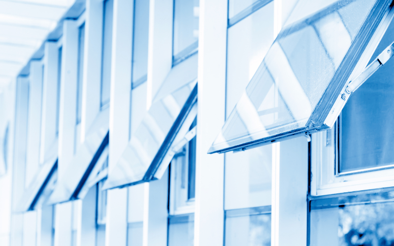 Blue-tinted awning windows opening away from a building