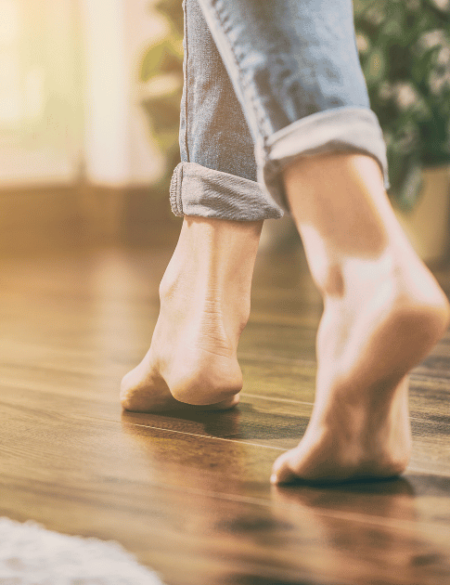 woman walking on wood floor